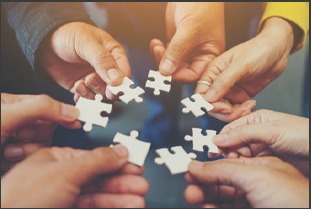 Hands connecting puzzle pieces as a partnership concept